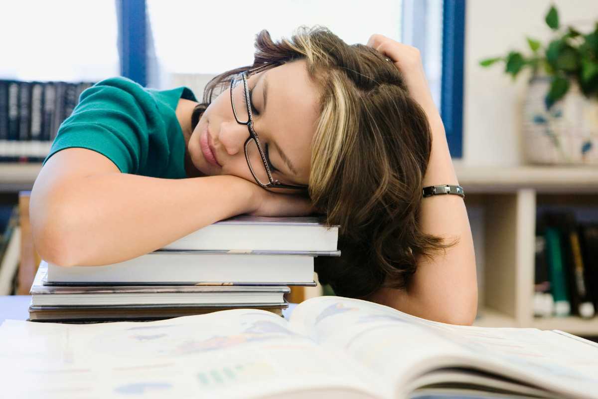 teenage sleeping with books