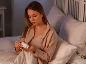 woman taking sleep aid pill