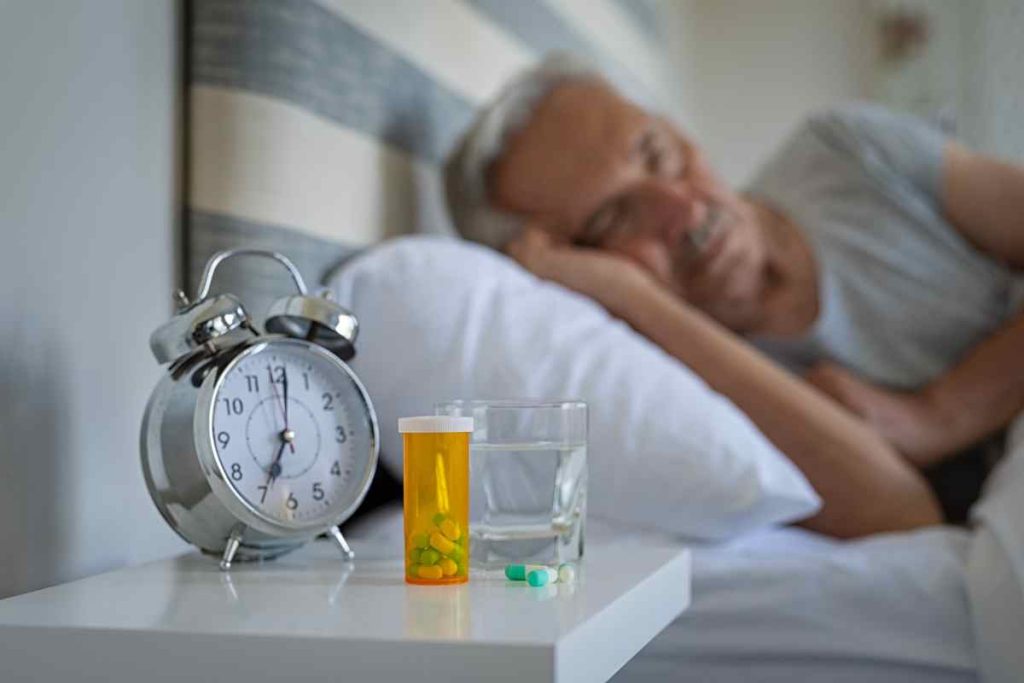 man sleeping with Narcolepsy Medication beside him