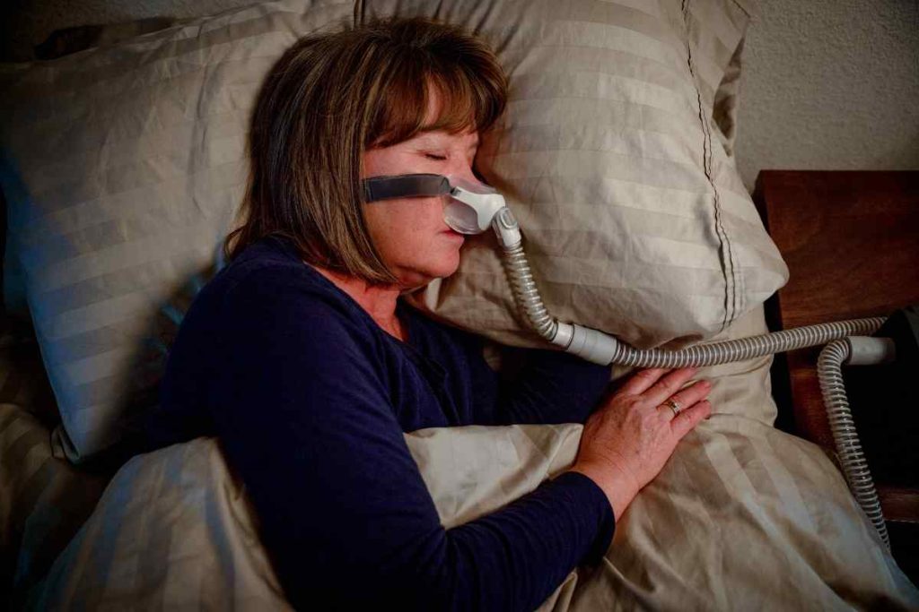 a woman wearing sleep apnea device
