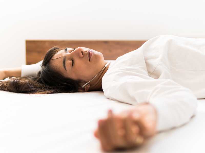 woman sleeping while listening to music