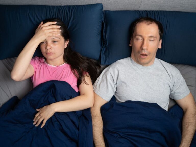 Husband and wife in bed with him snoring and her awake and not sleeping