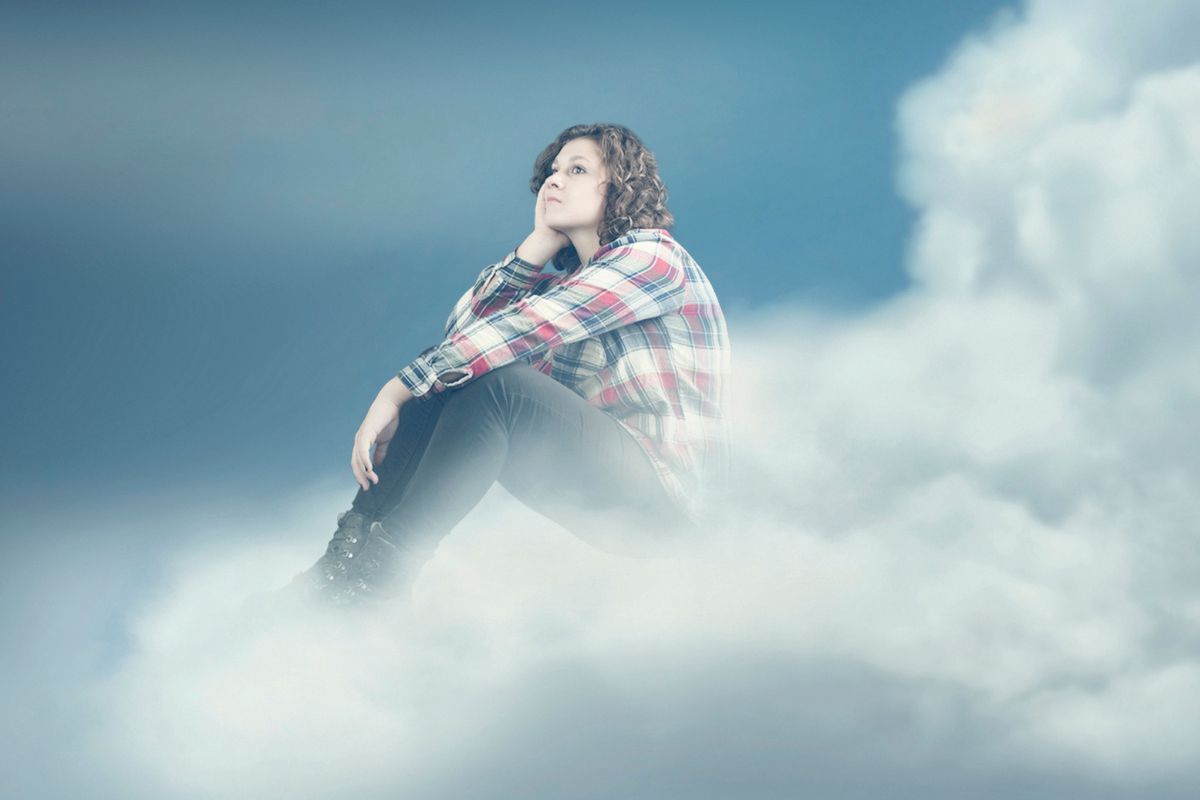 Lady in the clouds enjoying a lucid dream while sleeping