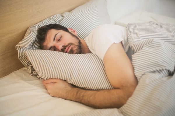 Man with his head on a pillow asleep in bed. Sleep Forums.